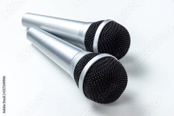 Obraz two black microphones without cords on a white table