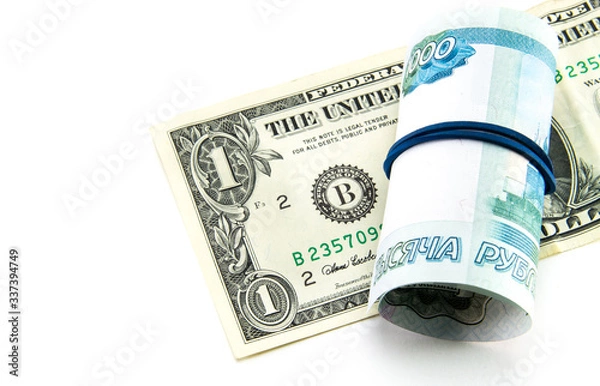 Fototapeta One US dollar and one thousand Russian rubles twisted into a tube on a white isolated background. Ruble collapse and currency exchange. 1000 tightened by an elastic band.
