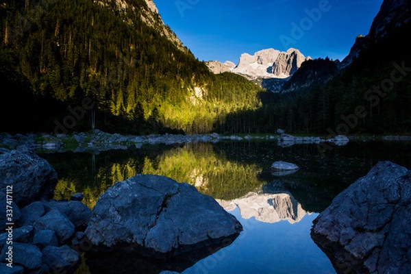 Obraz The Dachstein and a reflection at the Gosausee