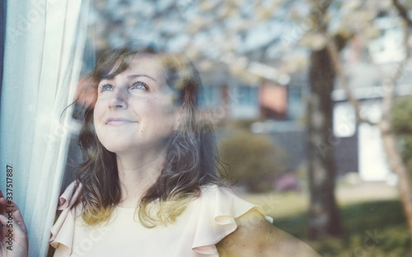Obraz Girl looking outside with hope during COVID-19 Lockdown spring time Oxford