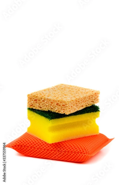 Fototapeta Different types of dish sponges, isolated on white background. Stacked orange, yellow and natural color sponges. Natural honeycomb sea sponge on top. Copy space for text.