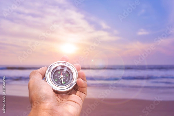 Obraz Hand holding Compass for finding direction