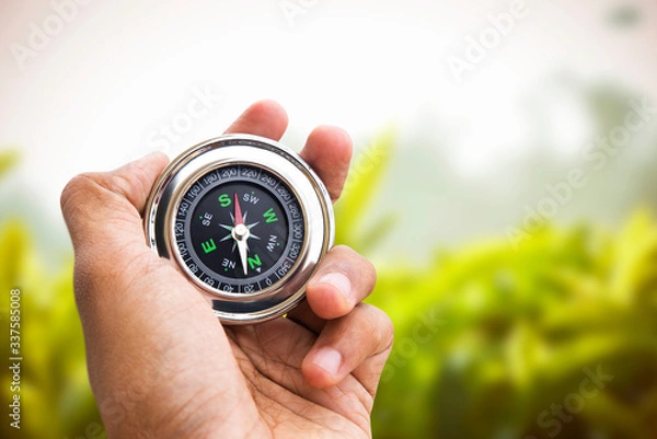 Obraz Hand holding Compass for finding direction