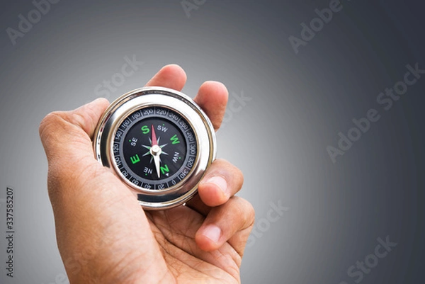 Obraz Hand holding Compass for finding direction