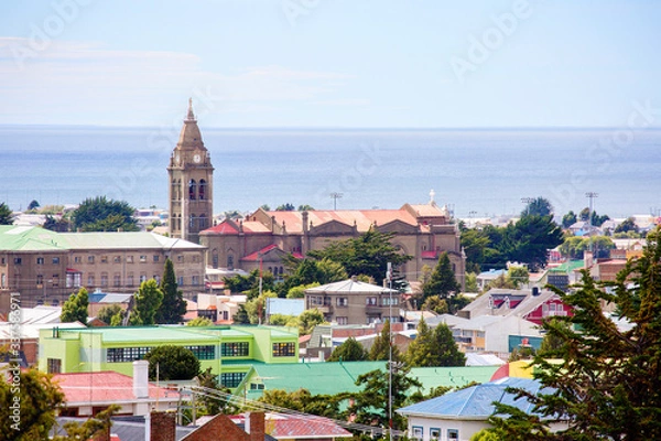Fototapeta Punta Arenas, Chile, Cityscape.
 View of the city and the Strait of Magellan from above. On the left you can see the tower with a spire. this is the largest Church in the city - the Sanctuary of Maria