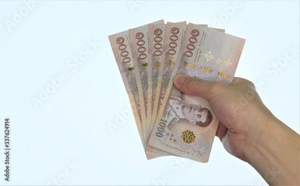 Obraz holding banknotes equal five thousand baht Thai