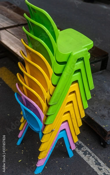 Obraz colorful staked plastic chairs 