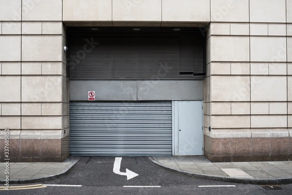 Fototapeta Closed gate in the street with arrow