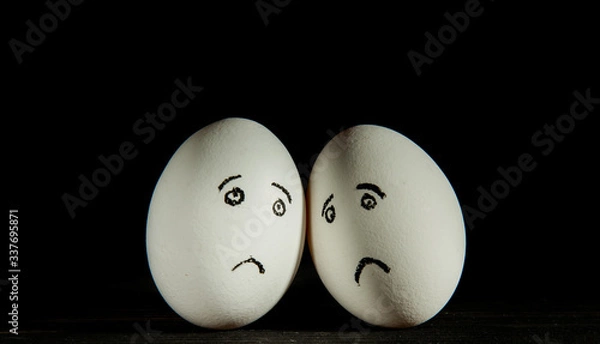 Obraz two sad eggs on a black background