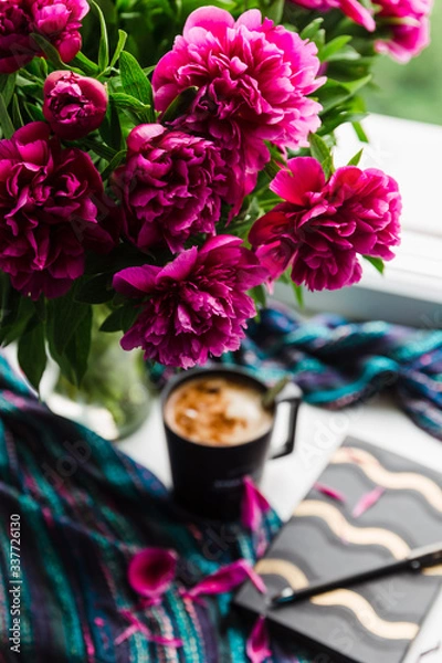 Obraz working at home idea. big peonies bouquet and a cup of coffee. spring at home. home decor and relaxation. coffee break and beautiful flowers, workplace at home, working at home
