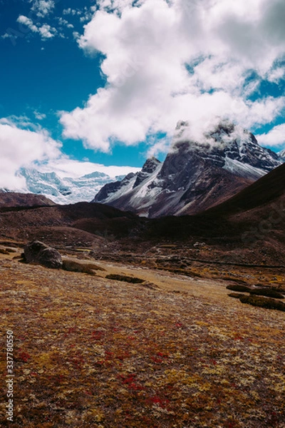 Fototapeta Beautiful mountain peaks and soft white clouds