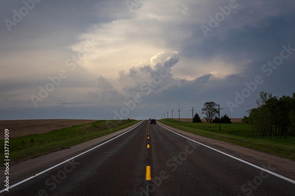 Fototapeta driving on the highway towards a storm