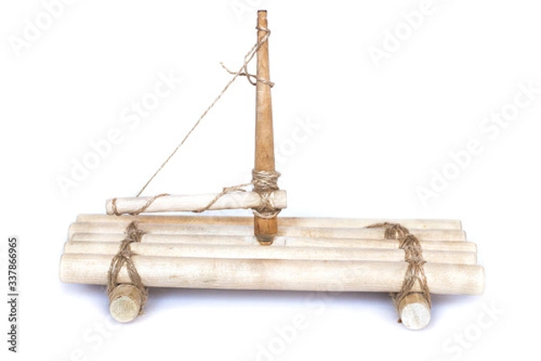 Fototapeta Toy wooden raft made of natural logs and ropes with a mast. Isolated on white background.