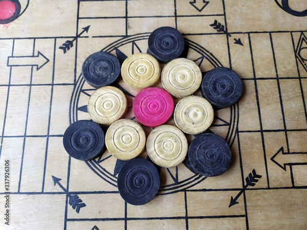 Fototapeta Carrom board or Karrom , carrom men, and queen. Close up