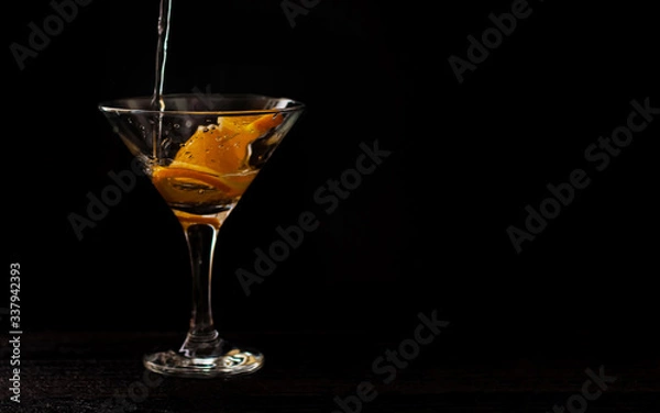 Obraz alcohol coctail on black background. cocktail with oranges. alcohol coctails are poured. horizontal banner for designers