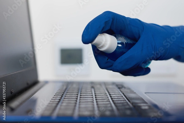 Obraz Disinfection gadget to protect from coronavirus covid-19 outbreak. Hand cleans with an antibacterial antiseptic sanitizer spray laptop