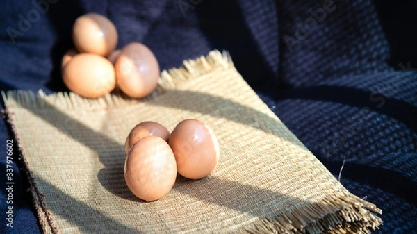 Fototapeta Chicken eggs with a black background, chicken eggs with natural light, chicken eggs are the food that every home needs, chicken eggs are very useful and protein.