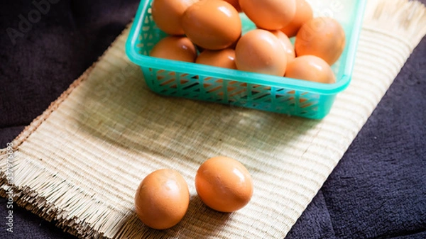 Fototapeta Chicken eggs with a black background, chicken eggs with natural light, chicken eggs are the food that every home needs, chicken eggs are very useful and protein.