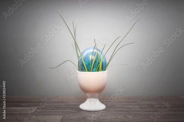 Fototapeta blue easter egg with grass