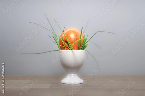 Fototapeta orange easter egg with grass