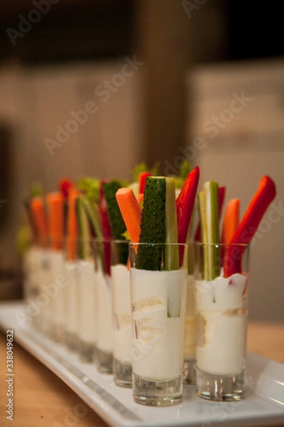 Fototapeta Cut vegetables in the sauce in the glass