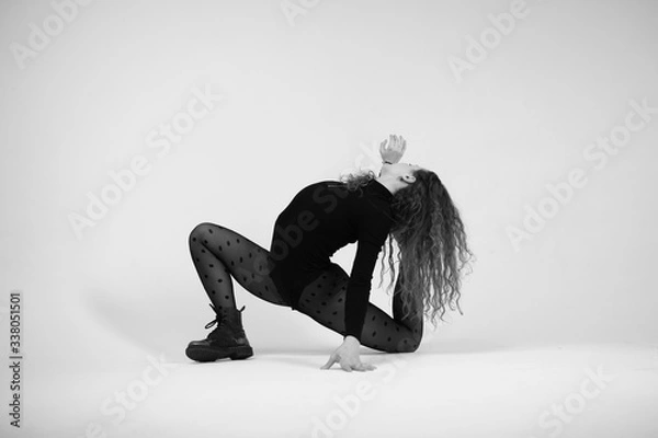 Fototapeta Stylish beautiful dancer wearing black leotard and black tights with polka dot on the white backgroud