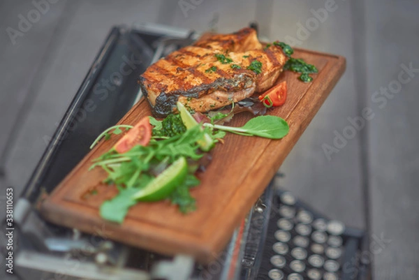 Obraz grilled salmon fish with vegetables on a wooden board
