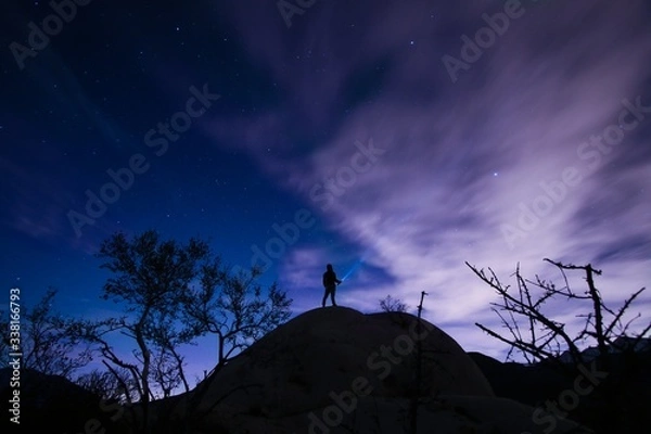 Obraz Man stargazing while standing on hilltop