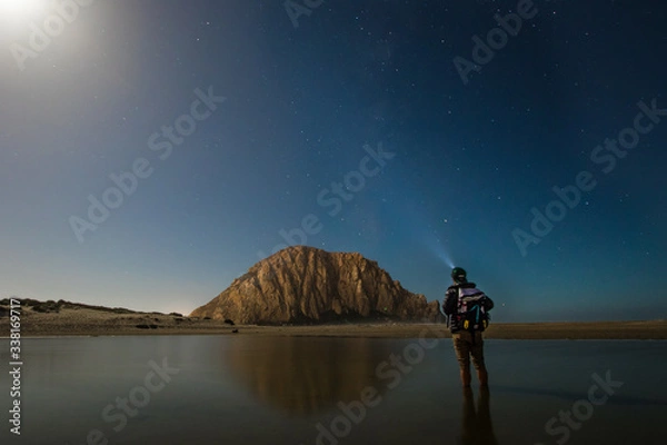 Obraz Rear view of man stargazing at Morro Rock Beach