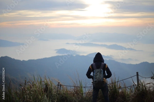 Fototapeta A man standing in the view at Phu Chi Fa National Park, Chiang Rai, Thailand