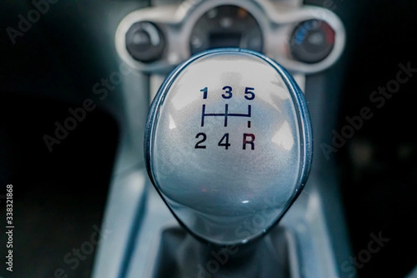 Obraz Extreme close up and selective focus of manual gear shifter with the background intentionally blurry