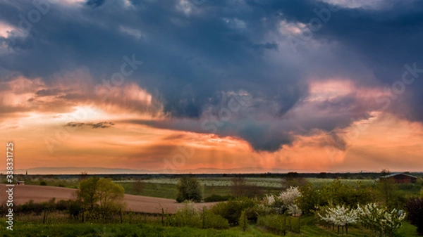 Fototapeta Dark sky with heavy clouds ober the Black Forest fields.