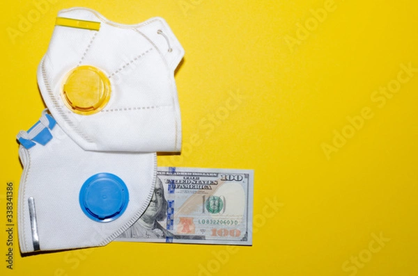 Fototapeta respirators and money on a yellow background