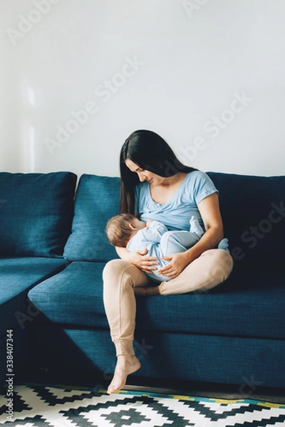 Obraz Mother is breast-feeding her son. The concept of breast-feeding, communication between mother and child, lactation, motherhood, stay home.