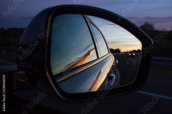 Fototapeta Car's rear mirror at sunset