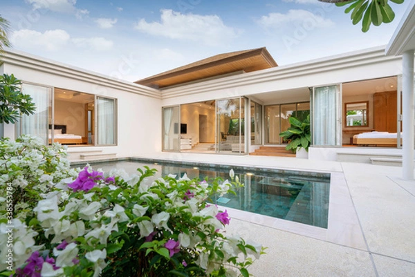 Fototapeta Exterior design of pool villa, house and home feature infinity swimming pool and garden
