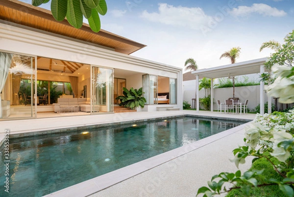 Fototapeta Exterior design of pool villa, house and home feature infinity swimming pool and garden