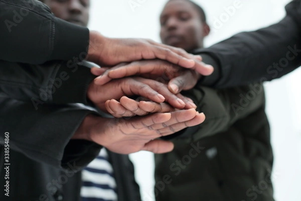 Obraz close up. a group of friends putting their hands togethe