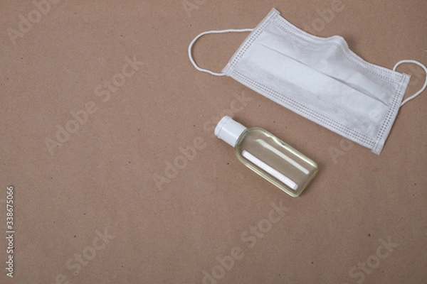 Fototapeta Medical mask and tube with antiseptic. Antibacterial agent for hands. Hand sanitizer.