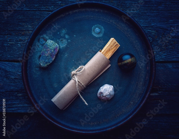 Fototapeta Stick of aromatic wood Palo Santo for meditation with different stones and minerals in a plate 