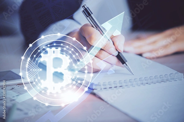 Fototapeta Cryptocurrency hologram over woman's hands writing background. Concept of blockchain. Multi exposure
