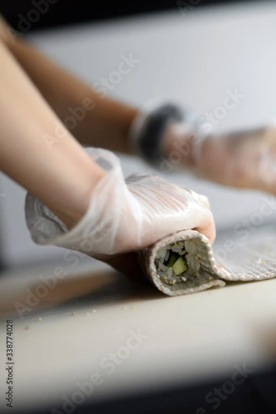 Obraz Rolling sushi with hands