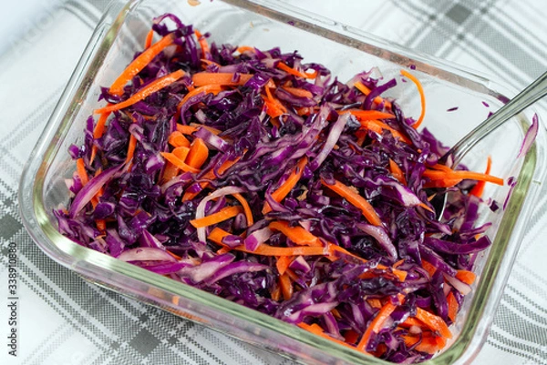 Fototapeta Vegetarian salad with shredded red cabbage and carrot.