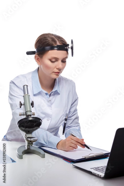 Fototapeta Healthcare and Medicine Concepts. Professional Laboratory Female Researcher in Smock Working With Microscope While Conducting a Research and Making Notes.