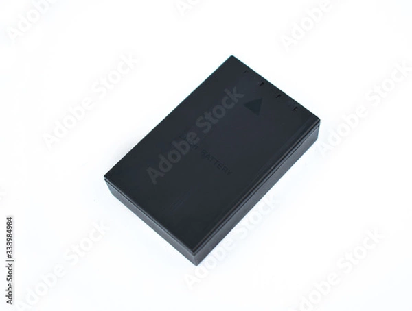 Fototapeta Battery of black color of a digital camera placed on top of a white background