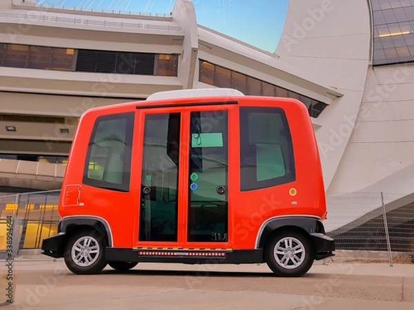 Obraz Bright red electric mini bus offering free transport to pedestrians