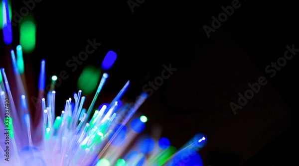 Obraz Closeup of bright multicolored luminous beams of light. Concept of of the modern technologies, big data, digital information. Technology banner with fiber optics network cable