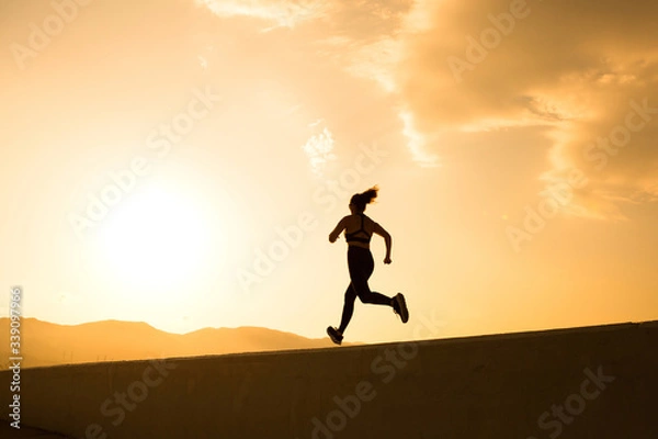 Obraz Woman is running in the morning preparing for marathon