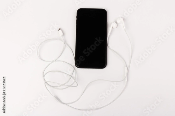 Fototapeta Creative flat lay photo of workspace desk with earphones and mobile phone