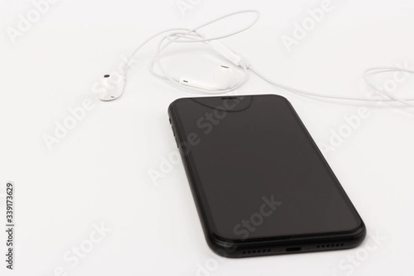 Fototapeta Creative flat lay photo of workspace desk with earphones and mobile phone